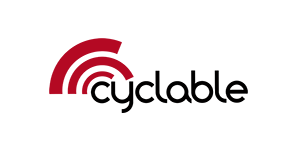Logo de Cyclable, en lettre minuscule arrondies noir. Trois arcs de cercles épais de tailles différentes rouge , viennent se former de la gauche du c, jusqu'au y.